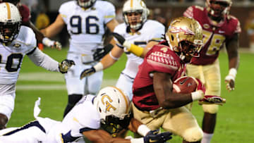 ATLANTA, GA - OCTOBER 24: Dalvin Cook #4 of the Florida State Seminoles is upended by Brentavious Glanton #97 of the Georgia Tech Yellow Jackets on October 24, 2015 at Bobby Dodd Stadium in Atlanta, Georgia. Photo by Scott Cunningham/Getty Images)