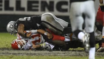 November 20, 2014; Oakland, CA, USA; Oakland Raiders outside linebacker Sio Moore (55, bottom) sacks Kansas City Chiefs quarterback Alex Smith (11) with help from Raiders outside linebacker Khalil Mack (52) during the fourth quarter at O.co Coliseum. The Raiders defeated the Chiefs 24-20. Mandatory Credit: Kyle Terada-USA TODAY Sports