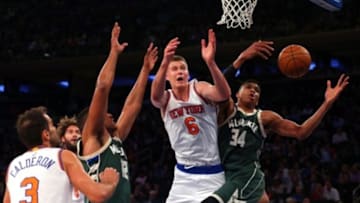 Nov 6, 2015; New York, NY, USA; Milwaukee Bucks small forward Giannis Antetokounmpo (34) grabs a rebound in front of New York Knicks power forward Kristaps Porzingis (6) during the first quarter at Madison Square Garden. Mandatory Credit: Brad Penner-USA TODAY Sports