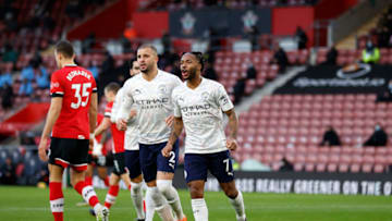 SOUTHAMPTON, ENGLAND - DECEMBER 19: Raheem Sterling of Manchester City celebrates with teammate Kyle Walker after scoring their sides first goal during the Premier League match between Southampton and Manchester City at St Mary's Stadium on December 19, 2020 in Southampton, England. A limited number of fans (2000) are welcomed back to stadiums to watch elite football across England. This was following easing of restrictions on spectators in tiers one and two areas only. (Photo by Adrian Dennis - Pool/Getty Images)