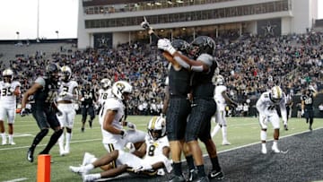 Cam Johnson #7 of the Vanderbilt Commodores celebrates with teammates after scoring the go ahead touchdown against the Missouri Tigers during the second half of a Vanderbilt 21-14 upset (Photo by Frederick Breedon/Getty Images)