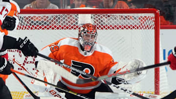 PHILADELPHIA, PENNSYLVANIA - OCTOBER 09: Through a maze of sticks, Carter Hart #79 of the Philadelphia Flyers keeps his eyes on the puck during the second period against the New Jersey Devils at the Wells Fargo Center on October 09, 2019 in Philadelphia, Pennsylvania. (Photo by Bruce Bennett/Getty Images)