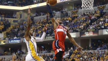 May 13, 2014; Indianapolis, IN, USA; Washington Wizards guard Bradley Beal (3) has a break away dunk against Indiana Pacers forward Paul George (24) at Bankers Life Fieldhouse. Mandatory Credit: Brian Spurlock-USA TODAY Sports