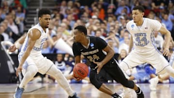 Mar 19, 2016; Raleigh, NC, USA; Providence Friars guard Kyron Cartwright (24) dribbles the ball between North Carolina Tar Heels guard Joel Berry II (2) and forward Justin Jackson (44) in the first half during the second round of the 2016 NCAA Tournament at PNC Arena. Mandatory Credit: Geoff Burke-USA TODAY Sports