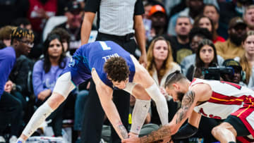 LaMelo Ball #1 of the Charlotte Hornets and Caleb Martin #16 of the Miami Heat fight for the ball in the fourth quarter(Photo by Jacob Kupferman/Getty Images)