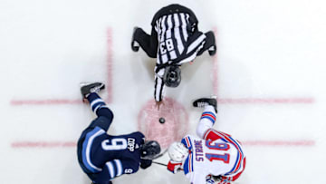 WINNIPEG, MB - FEBRUARY 12: Andrew Copp #9 of the Winnipeg Jets takes a second period face-off against Ryan Strome #16 of the New York Rangers at the Bell MTS Place on February 12, 2019 in Winnipeg, Manitoba, Canada. The Jets defeated the Rangers 4-3. (Photo by Jonathan Kozub/NHLI via Getty Images)