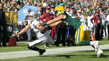 GREEN BAY, WISCONSIN - OCTOBER 20: Derek Carr #4 of the Oakland Raiders fumbles the ball as he dives for the pylon during the second quarter in the game at Lambeau Field on October 20, 2019 in Green Bay, Wisconsin. (Photo by Dylan Buell/Getty Images)