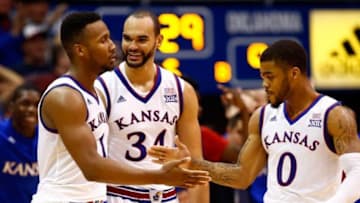 LAWRENCE, KS - JANUARY 04: Wayne Selden Jr. #1 of the Kansas Jayhawks is congratulated by Perry Ellis #34 and Frank Mason III #0 after making a three-pointer and drawing a foul during the second overtime of the game against the Oklahoma Sooners game at Allen Fieldhouse on January 4, 2016 in Lawrence, Kansas. The Jayhawks defeated the Sooners in triple overtime with a final score of 109-106 to win the game. (Photo by Jamie Squire/Getty Images)