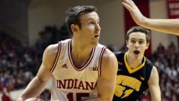 Feb 11, 2016; Bloomington, IN, USA; Indiana Hoosiers guard Harrison Niego (15) looks for an open teammate past Iowa Hawkeyes center Adam Woodbury (34) during the first period of the game at Assembly Hall. Mandatory Credit: Marc Lebryk-USA TODAY Sports