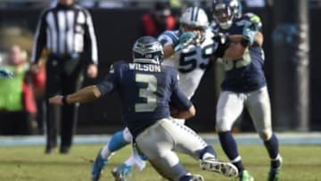 Jan 17, 2016; Charlotte, NC, USA; Seattle Seahawks quarterback Russell Wilson (3) runs as Carolina Panthers middle linebacker Luke Kuechly (59) defends during the third quarter in a NFC Divisional round playoff game at Bank of America Stadium. Mandatory Credit: John David Mercer-USA TODAY Sports