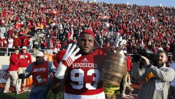 Nov 26, 2016; Bloomington, IN, USA; Indiana Hoosiers defensive lineman Ralph Green III (93) carries the Old Oaken Bucket and holds up four fingers for four consecutive victories in the Old Oaken Bucket game against the Purdue Boilermakers after the game at Memorial Stadium. Mandatory Credit: Brian Spurlock-USA TODAY Sports