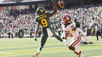 WACO, TX - NOVEMBER 13: Tyquan Thornton #9 of the Baylor Bears goes up for a pass in the end zone as Pat Fields #10 of the Oklahoma Sooners defends in the first half at McLane Stadium on November 13, 2021 in Waco, Texas. (Photo by Ron Jenkins/Getty Images)