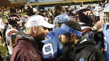 Oct 8, 2016; Chapel Hill, NC, USA; Virginia Tech Hokies head coach Justin Fuente with North Carolina Tar Heels head coach Larry Fedora after the game. The Hokies defeated the Tar Heels 34-3 at Kenan Memorial Stadium. Mandatory Credit: Bob Donnan-USA TODAY Sports