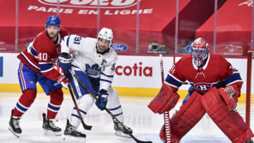 MONTREAL, QC - FEBRUARY 10: Joel Armia #40 of the Montreal Canadiens and John Tavares #91 of the Toronto Maple Leafs battle for position near goaltender Carey Price #31 during the third period at the Bell Centre on February 10, 2021 in Montreal, Canada. The Toronto Maple Leafs defeated the Montreal Canadiens 4-2. (Photo by Minas Panagiotakis/Getty Images)