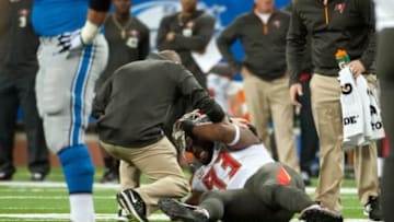 Dec 7, 2014; Detroit, MI, USA; Tampa Bay Buccaneers defensive tackle Gerald McCoy (93) is looked over by medical staff after being injured during the first quarter against the Detroit Lions at Ford Field. Mandatory Credit: Tim Fuller-USA TODAY Sports