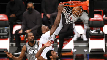Bam Adebayo #13 of the Miami Heat dunks as Kevin Durant #7 and Kyrie Irving #11 of the Brooklyn Nets defend(Photo by Sarah Stier/Getty Images)