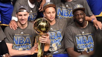 Jun 16, 2015; Cleveland, OH, USA; Golden State Warriors guard Klay Thompson (11), guard Stephen Curry (30) and Golden State Warriors forward Draymond Green (23) celebrates with the Larry O