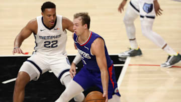 LOS ANGELES, CALIFORNIA - APRIL 21: Luke Kennard #5 of the LA Clippers handles the ball defended by Desmond Bane #22 of the Memphis Grizzlies at Staples Center on April 21, 2021 in Los Angeles, California. NOTE TO USER: User expressly acknowledges and agrees that, by downloading and or using this photograph, User is consenting to the terms and conditions of the Getty Images License Agreement. (Photo by Meg Oliphant/Getty Images)