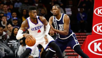Dec 5, 2014; Philadelphia, PA, USA; Philadelphia 76ers forward Nerlens Noel (4) looks for an open lane past Oklahoma City Thunder forward Kevin Durant (35) during the first quarter at Wells Fargo Center. Mandatory Credit: Bill Streicher-USA TODAY Sports