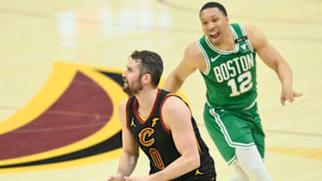 May 12, 2021; Cleveland, Ohio, USA; Cleveland Cavaliers forward Kevin Love (0) looks to shoot a three-point basket beside Boston Celtics forward Grant Williams (12) the third quarter at Rocket Mortgage FieldHouse. Mandatory Credit: David Richard-USA TODAY Sports