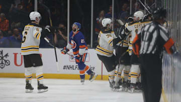 Jun 3, 2021; Uniondale, New York, USA; Boston Bruins players celebrate after defeating the New York Islanders in overtime of game three of the second round of the 2021 Stanley Cup Playoffs at Nassau Veterans Memorial Coliseum. Mandatory Credit: Brad Penner-USA TODAY Sports
