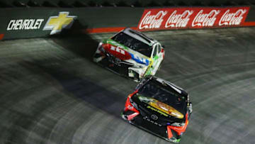 BRISTOL, TN - AUGUST 18: Martin Truex Jr., driver of the #78 Bass Pro Shops/Ducks Unlimited Toyota, leads Kyle Busch, driver of the #18 M and M's White Chocolate Toyota (Photo by Sarah Crabill/Getty Images)