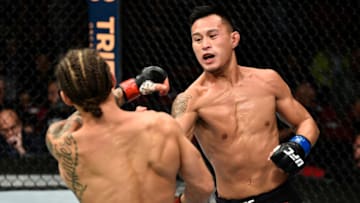 FRESNO, CA - DECEMBER 09: (R-L) Andre Soukhamthath punches Luke Sanders in their featherweight bout during the UFC Fight Night event inside Save Mart Center on December 9, 2017 in Fresno, California. (Photo by Jeff Bottari/Zuffa LLC/Zuffa LLC via Getty Images)