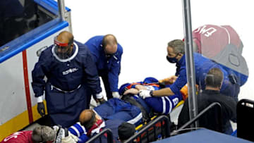 Jake Muzzin of the Toronto Maple Leafs is carried off the ice. (Photo by Andre Ringuette/Freestyle Photo/Getty Images)