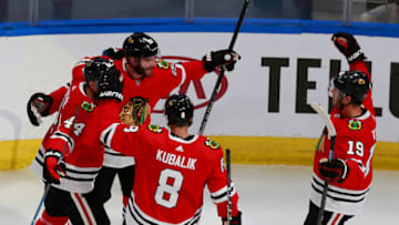 Brandon Saad #20 is congratulated by his teammates after scoring a goal against the Edmonton Oilers during the first period in Game Four of the Western Conference Qualification Round. (Photo by Jeff Vinnick/Getty Images)