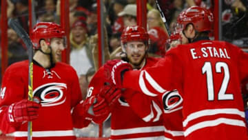 Jan 12, 2016; Raleigh, NC, USA; Carolina Hurricanes forward Kris Versteeg (32) celebrates with forward Eric Staal (12), forward Elias Lindholm (16), and defensemen Brett Pesce (54) after scoring a goal against the Pittsburgh Penguins in the second period at PNC Arena. Mandatory Credit: James Guillory-USA TODAY Sports