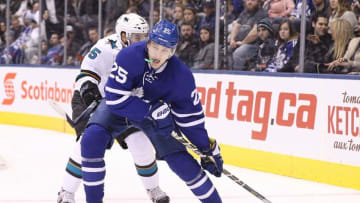 Dec 13, 2016; Toronto, Ontario, CAN; Toronto Maple Leafs left wing James van Riemsdyk (25) skates ariund the net with the puck as San Jose Sharks defenseman David Schlemko (5) pursues at Air Canada Centre. Mandatory Credit: Tom Szczerbowski-USA TODAY Sports