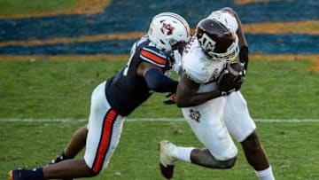 Auburn football defensive back Jamien Sherwood (20) hits Texas A&M tight end Jalen Wydermyer (85) to cause and incompletion at Jordan-Hare Stadium in Auburn, Ala., on Saturday, Dec. 5, 2020. Texas A&M defeated Auburn 31-20.