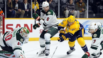 Dec 19, 2015; Nashville, TN, USA; Nashville Predators left winger James Neal (18) reaches to attempt a shot on Minnesota Wild goalie Devan Dubnyk (40) while defended by defenseman Marco Scandella (6) during the first period at Bridgestone Arena. Mandatory Credit: Christopher Hanewinckel-USA TODAY Sports