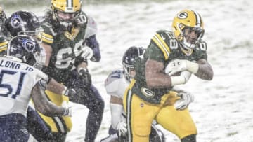 Dec 27, 2020; Green Bay, Wisconsin, USA; Green Bay Packers running back AJ Dillon (28) carries the ball in the second quarter during the game against the Tennessee Titans at Lambeau Field. Mandatory Credit: Benny Sieu-USA TODAY Sports