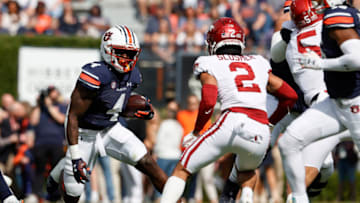 Oct 29, 2022; Auburn, Alabama, USA; Auburn Tigers running back Tank Bigsby (4) carries as Arkansas Razorbacks defensive back Myles Slusher (2) closes in during the first quarter at Jordan-Hare Stadium. Mandatory Credit: John Reed-USA TODAY Sports