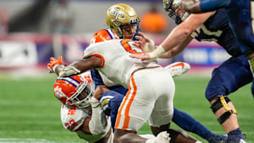 Sep 5, 2022; Atlanta, Georgia, USA; Georgia Tech Yellow Jackets running back Dontae Smith (4) is tackled by Clemson Tigers linebacker Trenton Simpson (22) and linebacker Barrett Carter (0) during the first half at Mercedes-Benz Stadium. Mandatory Credit: Dale Zanine-USA TODAY Sports