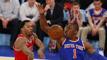 Mar 24, 2016; New York, NY, USA; Chicago Bulls guard Derrick Rose (1) passes the ball past New York Knicks center Kevin Seraphin (1) during second half at Madison Square Garden. The Knicks won 106-94. Mandatory Credit: Noah K. Murray-USA TODAY Sports