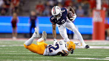 TUCSON, ARIZONA - SEPTEMBER 16: Defensive back Josiah Allen #22 of the UTEP Miners tackles wide receiver Jacob Cowing #2 of the Arizona Wildcats during the first half of the college football game at Arizona Stadium on September 16, 2023 in Tucson, Arizona. (Photo by Chris Coduto/Getty Images)