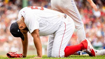 BOSTON, MA - JULY 14: Eduardo Rodriguez #57 of the Boston Red Sox reacts after colliding with Lourdes Gurriel Jr. after covering first base and recording the out during the sixth inning of a game against the Toronto Blue Jays on July 14, 2018 at Fenway Park in Boston, Massachusetts. (Photo by Billie Weiss/Boston Red Sox/Getty Images)