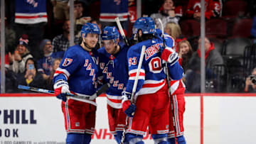 NEWARK, NEW JERSEY - NOVEMBER 30: Brady Skjei #76 of the New York Rangers is congratulated by teammates Jesper Fast #17,Tony DeAngelo #77 and Mika Zibanejad #93 after Skjei scored an empty net goal in the third period against the New Jersey Devils at Prudential Center on November 30, 2019 in Newark, New Jersey.The New York Rangers defeated the New Jersey Devils 4-0. (Photo by Elsa/Getty Images)