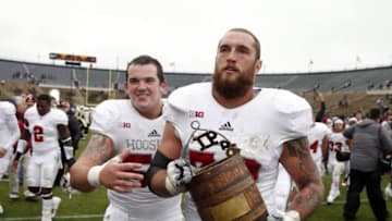 Nov 28, 2015; West Lafayette, IN, USA; Indiana Hoosiers center Jake Reed (50) and offensive tackle Jason Spriggs (78) walk off the field carrying the Old Oaken Bucket after the victory against the Purdue Boilermakers at Ross Ade Stadium. Indiana defeats Purdue 54-36. Mandatory Credit: Brian Spurlock-USA TODAY Sports
