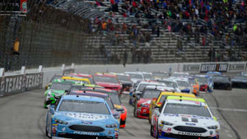 FORT WORTH, TX - APRIL 08: Kevin Harvick, driver of the #4 Busch Light Ford, and Clint Bowyer, driver of the #14 Mobil 1/Rush Truck Centers Ford, lead the field to a restart during the Monster Energy NASCAR Cup Series O'Reilly Auto Parts 500 at Texas Motor Speedway on April 8, 2018 in Fort Worth, Texas. (Photo by Robert Laberge/Getty Images)