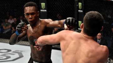 PERTH, AUSTRALIA - FEBRUARY 11: (L-R) Israel Adesanya of Nigeria punches Rob Wilkinson of Australia in their middleweight bout during the UFC 221 event at Perth Arena on February 11, 2018 in Perth, Australia. (Photo by Jeff Bottari/Zuffa LLC/Zuffa LLC via Getty Images)