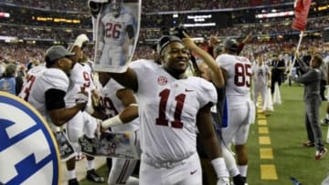 Dec 6, 2014; Atlanta, GA, USA; Alabama Crimson Tide linebacker Shaun Dion Hamilton (11) holds up a newspaper after the 2014 SEC Championship Game against the Missouri Tigers at the Georgia Dome. Alabama defeated Missouri 42-13. Mandatory Credit: Dale Zanine-USA TODAY Sports