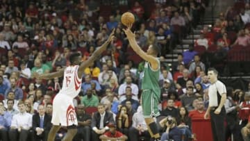 Nov 16, 2015; Houston, TX, USA; Boston Celtics guard Avery Bradley (0) shoots against Houston Rockets center Clint Capela (15) in the second half at Toyota Center. Celtics won 111 to 95. Mandatory Credit: Thomas B. Shea-USA TODAY Sports