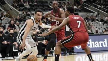 San Antonio Spurs guard Tre Jones (33) drives to the basket while defended by Miami Heat guard Kyle Lowry (7) and center Bam Adebayo (13)(Scott Wachter-USA TODAY Sports)