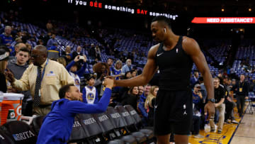 OAKLAND, CA - DECEMBER 29: Dwight Howard #12 of the Charlotte Hornets talks to Stephen Curry #30 of the Golden State Warriors before their game at ORACLE Arena on December 29, 2017 in Oakland, California. NOTE TO USER: User expressly acknowledges and agrees that, by downloading and or using this photograph, User is consenting to the terms and conditions of the Getty Images License Agreement. (Photo by Lachlan Cunningham/Getty Images)