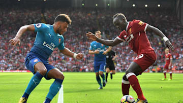 LIVERPOOL, ENGLAND - AUGUST 27: Sadio Mane of Liverpool and Alex Oxlade-Chamberlain of Arsenal battle for possession during the Premier League match between Liverpool and Arsenal at Anfield on August 27, 2017 in Liverpool, England. (Photo by Michael Regan/Getty Images)