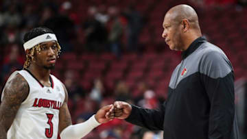 A downcast El Ellis gets a fistbump from Louisville head coach Kenny Payne as the guard leaves the game for good late in the second half against Pitt at the KFC Center Wednesday night. The Cards lost 75-54 to the visiting Panthers. Ellis finished with 19 points and five of the team's six assists. Jan. 18, 2023Louisville Vs Pitt Jan 18 2023Syndication The Courier Journal