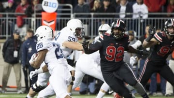 Oct 17, 2015; Columbus, OH, USA; Ohio State Buckeyes defensive lineman Adolphus Washington (92) breaks past Penn State Nittany Lions offensive tackle Andrew Nelson (59) in pursuit of running back Saquon Barkley (26) at Ohio Stadium. Ohio State won the game 38-10. Mandatory Credit: Greg Bartram-USA TODAY Sports